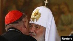 Kirill, the patriarch of Moscow and All Russia, greets Cardinal Kazimierz Nycz (left), the archbishop of Warsaw.