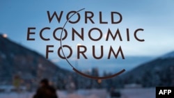 Switzerland -- The logo of the World Economic Forum (WEF) is seen on window pane at the Congress Center prior to the forum's annual meeting in Davos, January 18, 2016