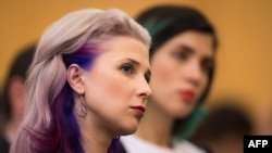 Pussy Riot band member and political activist Maria Alyokhina attends the "Prospects for Russia after Putin" debate in the Houses of Parliament in London in November 2014 (with bandmate Nadezhda Tolokonnikova in background).
