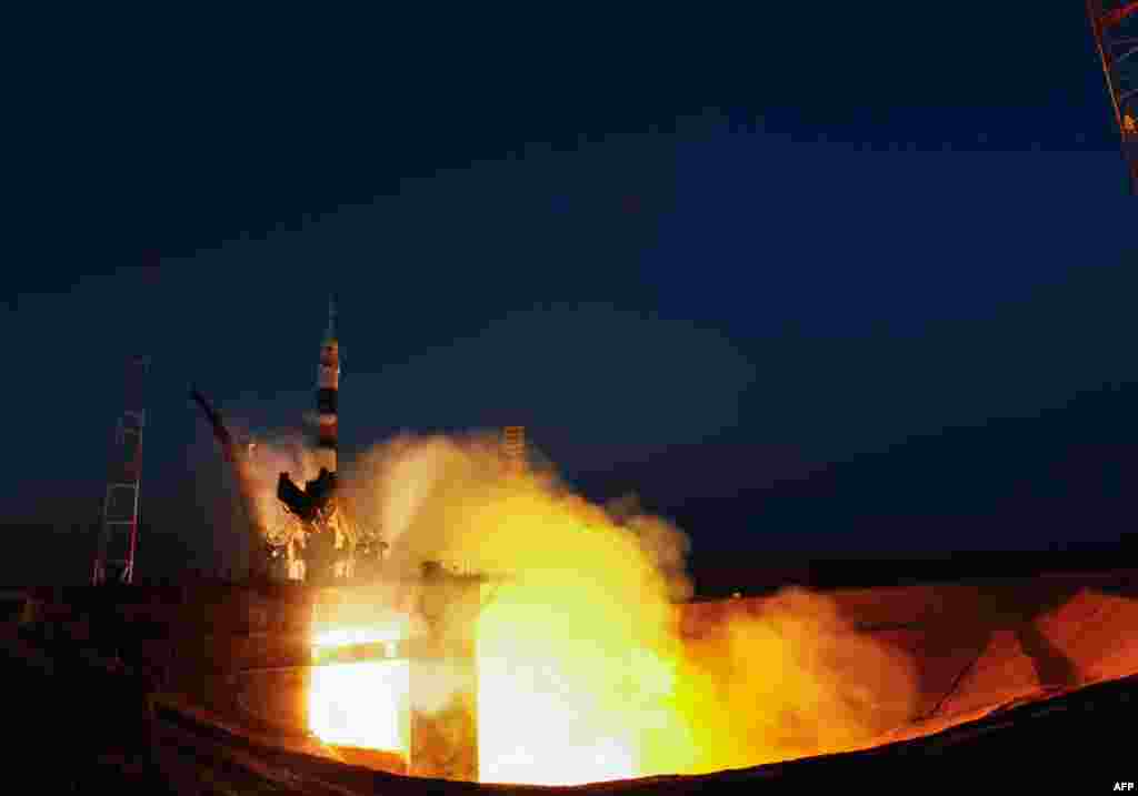 A NASA handout picture shows a rocket booster with a Soyuz TMA-07M spaceship bound for the International Space Station blasting off from the Russian-leased Baikonur Cosmodrome in Kazakhstan. (AFP/NASA/Carla Cioffi)