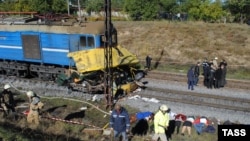 Police officers and firefighters work at the crash site in Ukraine's Dnipropetrovsk region.