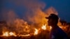 A labourer stares at a fire that spread to the farm he work on next to a highway in Nova Santa Helena municipality in northern Mato Grosso State, south in the Amazon basin in Brazil, on August 23, 2019. - Official figures show 78,383 forest fires have bee