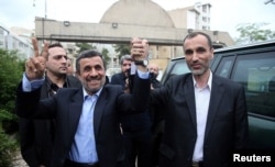 Ahmadinejad with his former vice president, Hamid Baghaei, after registering as a presidential candidate on April 12.