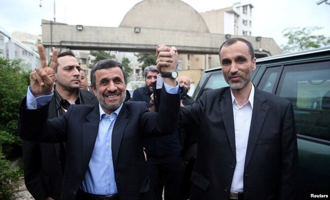 Ahmadinejad with his former vice president, Hamid Baghaei, after registering as a presidential candidate on April 12.