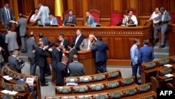 Ukrainian opposition deputies block a platform inside the Ukrainian parliament in Kyiv to prevent the session taking place on June 7.