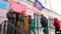 Armed security men guard a polling station during the elections in Donetsk on November 2.