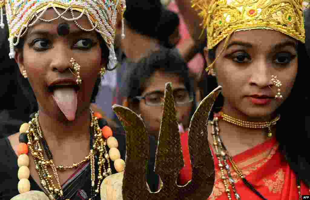 Indian college students dressed as Hindu goddesses take part in a rally in Mumbai on September 25 that was held to demand more safety for women in the country. (AFP/Punit Paranjpe)