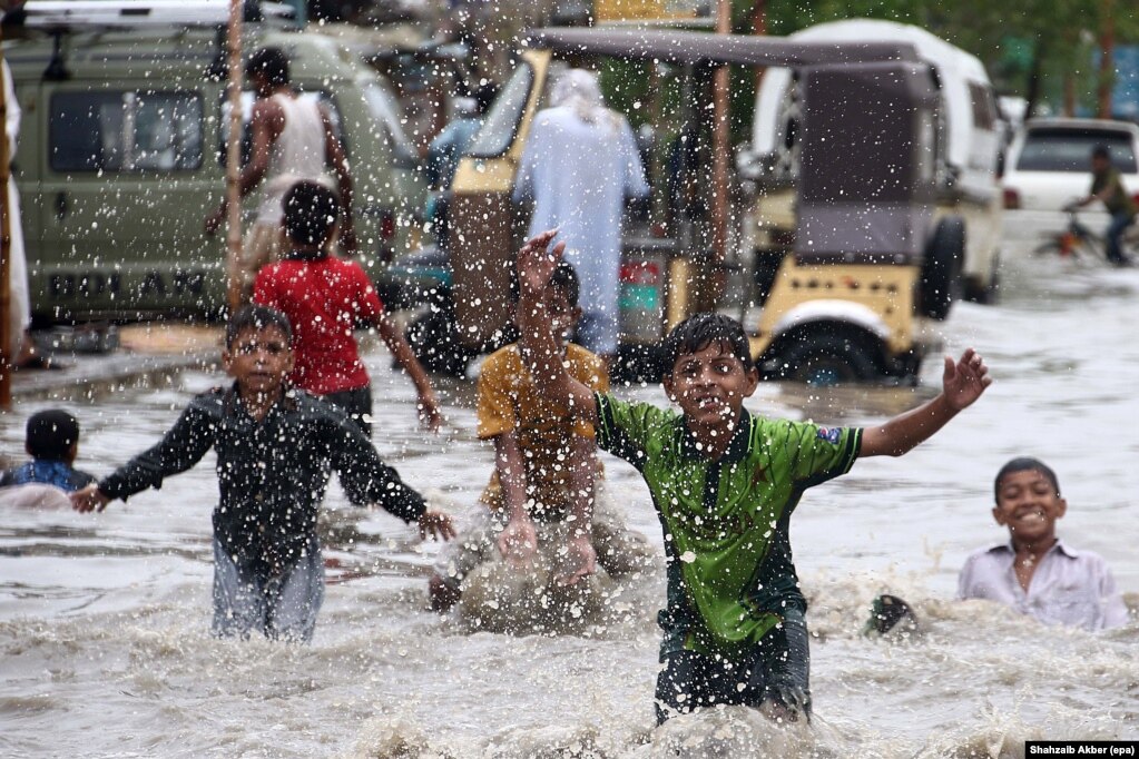 Street children enjoy themselves as the monsoon rains flood the streets of Karachi, Pakistan. (epa/Shahzaib Akber)