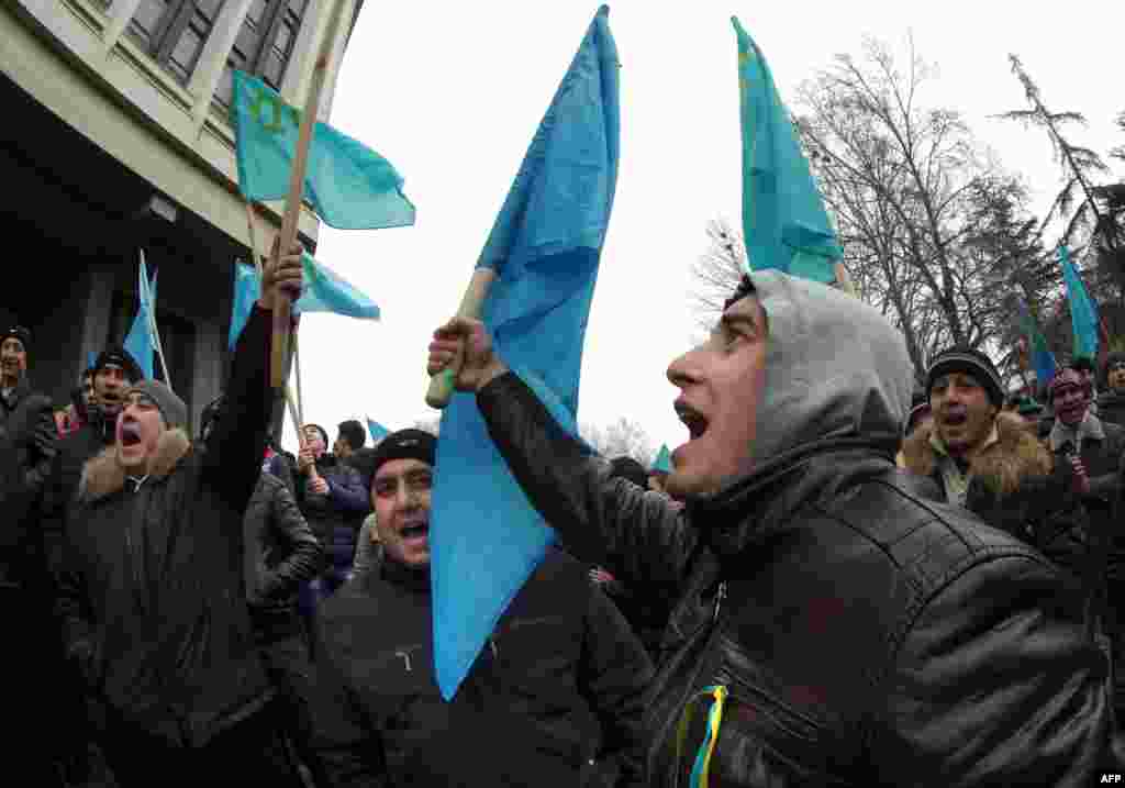 Pro-Ukrainian activists shout during a rally in front of the Crimean parliament.