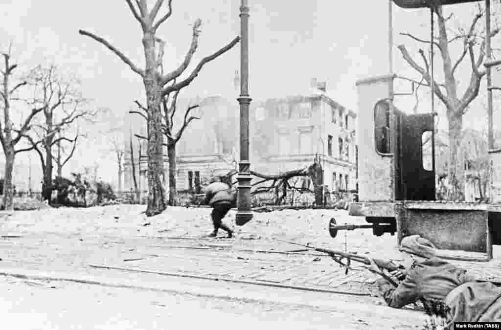 Soviet soldiers advancing through western Poland in January 1945. One month later, Allied troops were massed on Nazi Germany's western border and the Red Army was storming through the eastern part of Germany. 