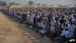 Afghan refugees offer prayers on the outskirts of Peshawar. (file photo)