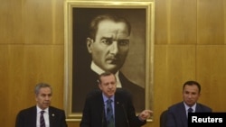 Turkish Prime Minister Recep Tayyip Erdogan (center), accompanied by deputies Bulent Arinc (left) and Bekir Bozdag, speaks during a news conference at Ataturk International Airport in Istanbul on June 3.