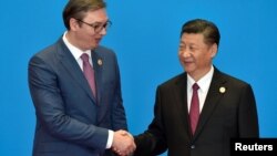 Serbian President Aleksandar Vucic (left) has sought to build a warm relationship with Chinese President Xi Jinping (file photo)