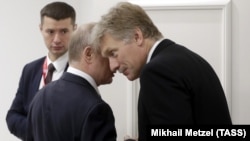 Kremlin spokesman Dmitry Peskov (right) with his boss, Vladimir Putin. (file photo)