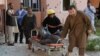 A body is removed from the scene of a suicide attack that targeted the Afghan state television building in Jalalabad in May.