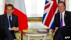 British Prime Minister David Cameron, right, and French President Nicolas Sarkozy agree to a new military partnership at a press conference in London.