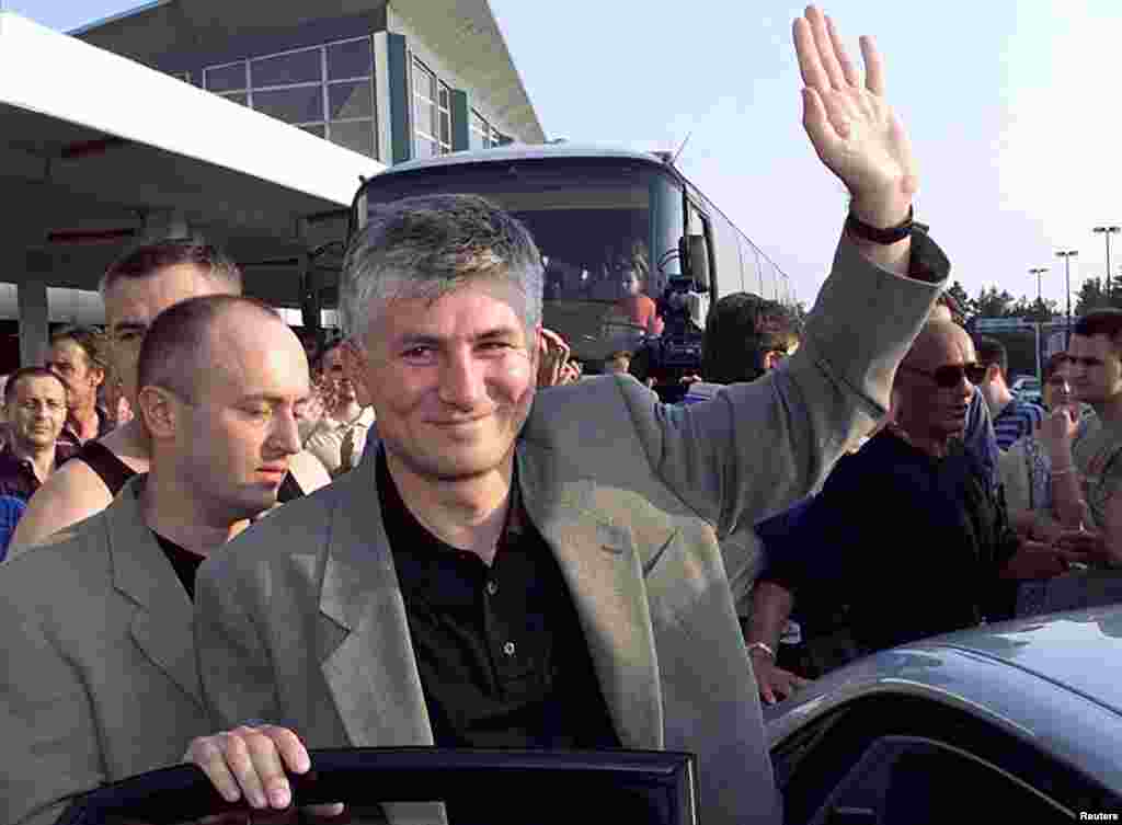 Djindjic waves to supporters who had gathered at the airport upon his arrival in Belgrade on July 4, 1999. Djindjic had left Belgrade after the beginning of the NATO air strikes against Yugoslavia, facing charges of draft evasion that carried up to 20 years in prison.