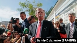 U.S. national-security adviser John Bolton speaks to the media after a wreath-laying ceremony at the memorial for soldiers killed in the conflict in eastern Ukraine in Kyiv on August 27. 