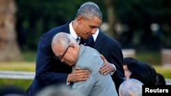 U.S. President Barack Obama (left) hugs atomic bomb survivor Shigeaki Mori as he visits the Hiroshima Peace Memorial Park in Japan on May 27.