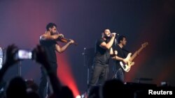 Lebanon - Hamed Sinno (C), the lead singer of Lebanese alternative rock band Mashrou' Leila performs with his band during a concert in Beirut, Lebanon, August 6, 2015