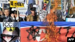 Conservative activists burn a North Korean flag and a portrait of its leader Kim Jong Il during a rally in Seoul on November 11.