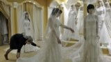Chechnya -- A young woman tries on a wedding dress in an upmarket wedding salon in Grozny, 10Mar2011