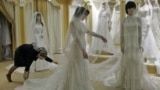 Chechnya -- A young woman tries on a wedding dress in an upmarket wedding salon in Grozny, 10Mar2011