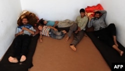 Afghan refugees sit at a UN refugee agency center in Herat after being deported from Iran in September.