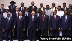 Russian President Vladimir Putin waves to the camera as he poses with African leaders at the Russia-Africa Summit in Sochi in October 2019. 