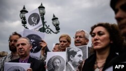 Turkey -- Human rights activists hold placards picturing Armenian intellectuals, detained and executed in 1915, during a rally in Istanbul, April 24, 2016