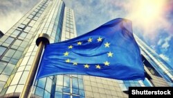 Belgium - An EU flag flying in front of European Parliament building in Brussels.