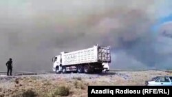 Smoke billows out from the site of the explosions.