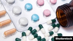 Illustration - Capsules and pills with bottle on white background