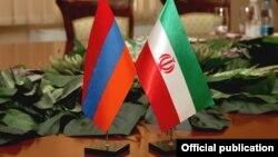 Armenia - Armenian and Iranian flags put on a table during bilateral talks in Yerevan, 29Aug2014.