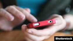 Czech republic. Hands holding smartphone. social media. Shutterstock.