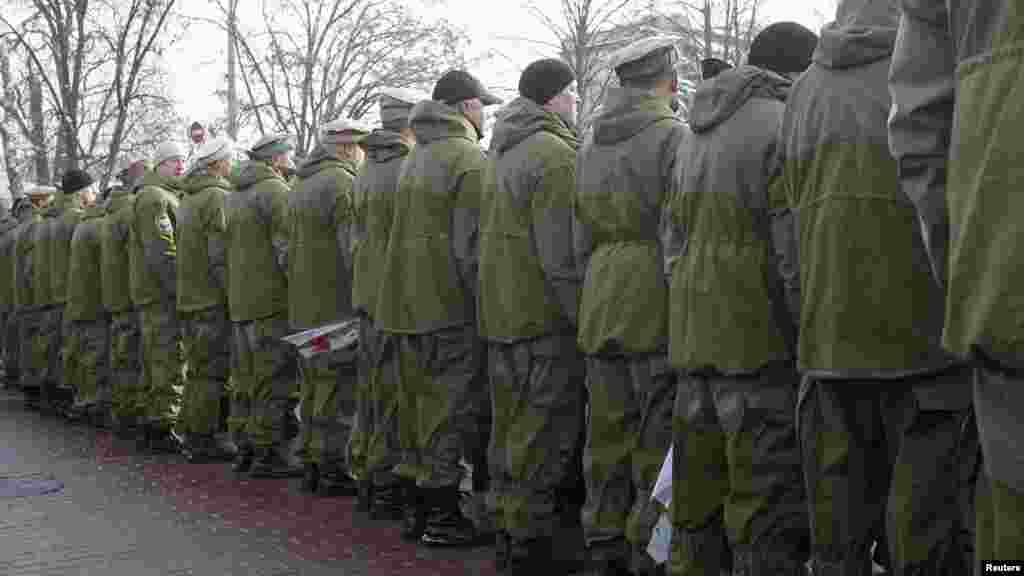 Veterans of the Soviet war in Afghanistan stand with their backs turned to Ukrainian President Viktor Yanukovych as he attends a flower-laying ceremony in Kyiv on February 15. The veterans publicly snubbed Yanukovych during the ceremony marking the 23rd anniversary of the withdrawal of Soviet forces from Afghanistan. (REUTERS/Gleb Garanich)