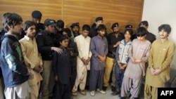 Police produce young children suspected of planting bombs to the media in Quetta on March 13.