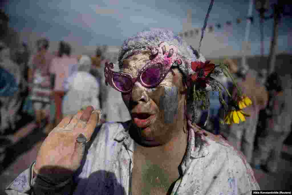 A reveler celebrates Ash Monday by participating in a colorful &quot;flour war,&quot; a traditional festivity marking the end of the carnival season and the start of the 40-day Lent period until Orthodox Easter, in the port town of Galaxidi, Greece, on March 11. (Reuters/Alkis Konstantinidis)