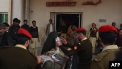 Pakistani soldiers shift an injured victim from a passenger bus hit in cross-border shelling, at a military hospital in Muzaffarabad, the capital of Pakistan-administered Kashmir, on November 23.