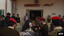 Pakistani soldiers shift an injured victim from a passenger bus hit in cross-border shelling, at a military hospital in Muzaffarabad, the capital of Pakistan-administered Kashmir, on November 23.