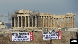 Antiausterity banners hang outside the Parthenon Temple in Athens on February 11.