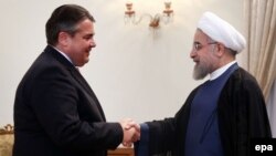 Iranian President Hassan Rohani (right) meets with German Economy Minister Sigmar Gabriel at the presidential office in Tehran on July 20.