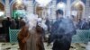 Smoking Syrian Rue, a plant believed to cure sickness in Masoumeh Shrine in Qom on February 25, 2020