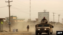 Afghan security forces travel in a Humvee vehicle to aid colleagues fighting Taliban militants in the northern city of Kunduz on September 28.