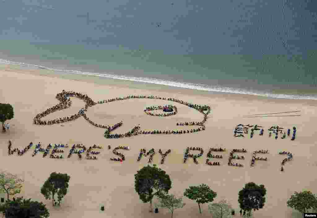 A view of more than 800 schoolchildren, teachers, and volunteers forming the shape of a fish with a sad expression, alongside Chinese characters that read "refrain," at Repulse Bay in Hong Kong. The event was in honor of Kids Ocean Day, to send a global message to stop consuming reef fish in order to protect the Earth's coral reefs. (Reuters/Bobby Yip)
