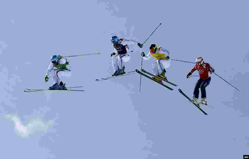 France's Jean Frederic Chapuis, Arnaud Bovolenta, and Jonathan Midol, followed by Brady Leman of Canada, in action during the men's ski-cross final. France's skiers won all three medals. (epa/Valdrin Xhemaj)