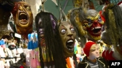 Morbid fixation? Halloween masks hang in a shop window in New York City on October 30.