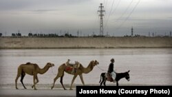 A transmission line across the Amu Darya river bringing power from Uzbekistan into Afghanistan, which is dependent on its neighbors for much of its electricity. (file photo) 