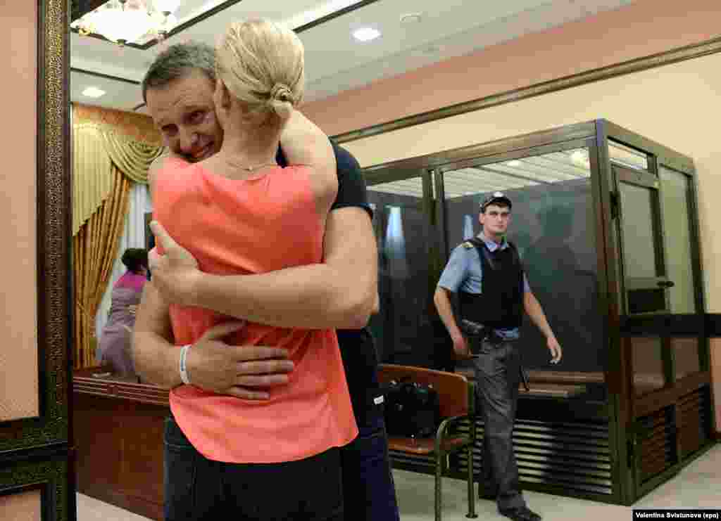 Russian opposition leader Aleksei Navalny embraces his wife Yulia after he was freed by the Kirov regional court on a suspended sentence on July 19. Navalny was convicted for financial crimes, charges he says are politically motivated.