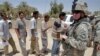 Iraq - US soldiers stand guard as Iraqis arrive at an army and police recruitment center in Latifiyah south of Baghdad, in what is known as the triangle of death, 21May2008